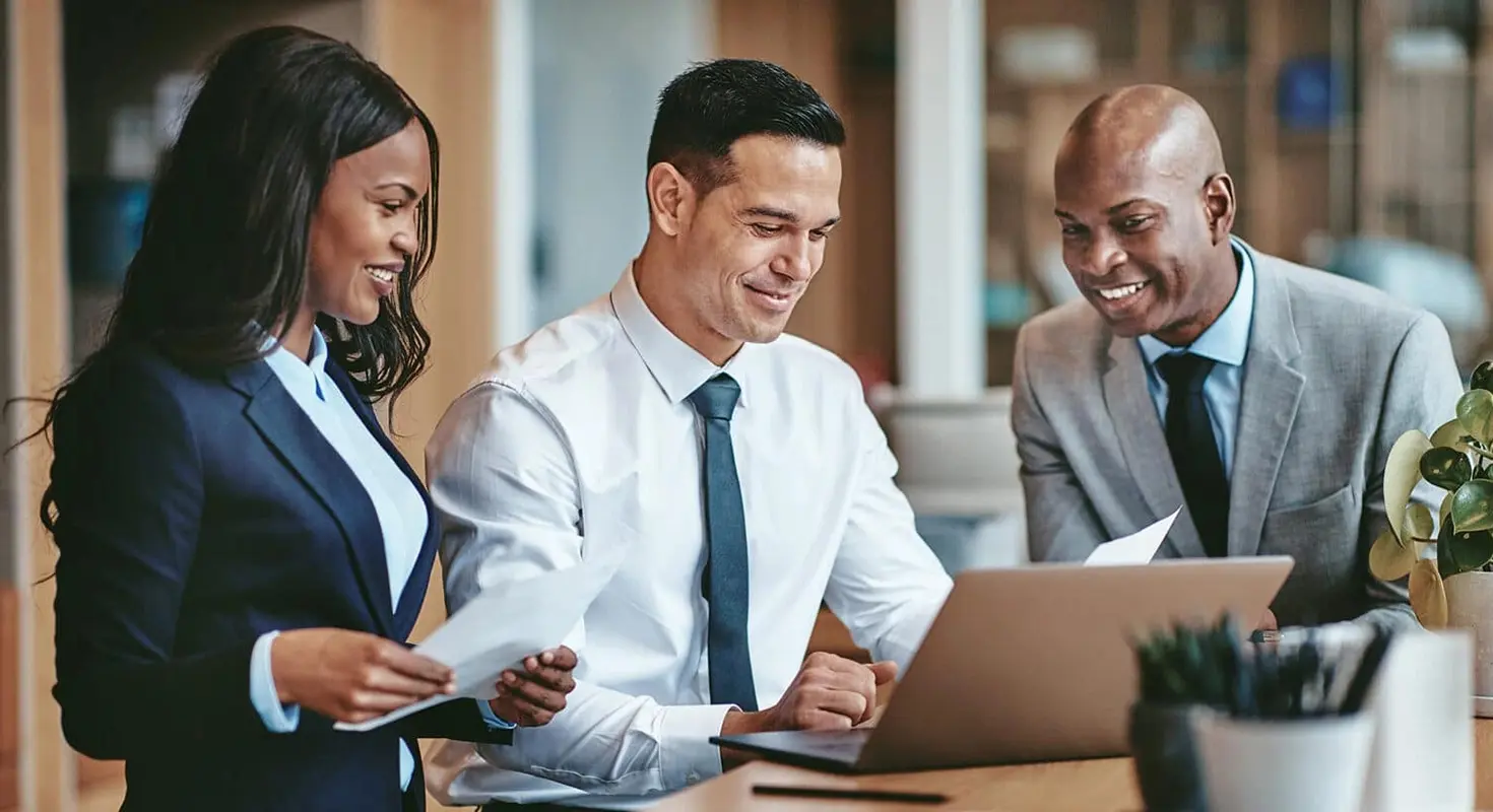 Co-workers collaborating over a laptop